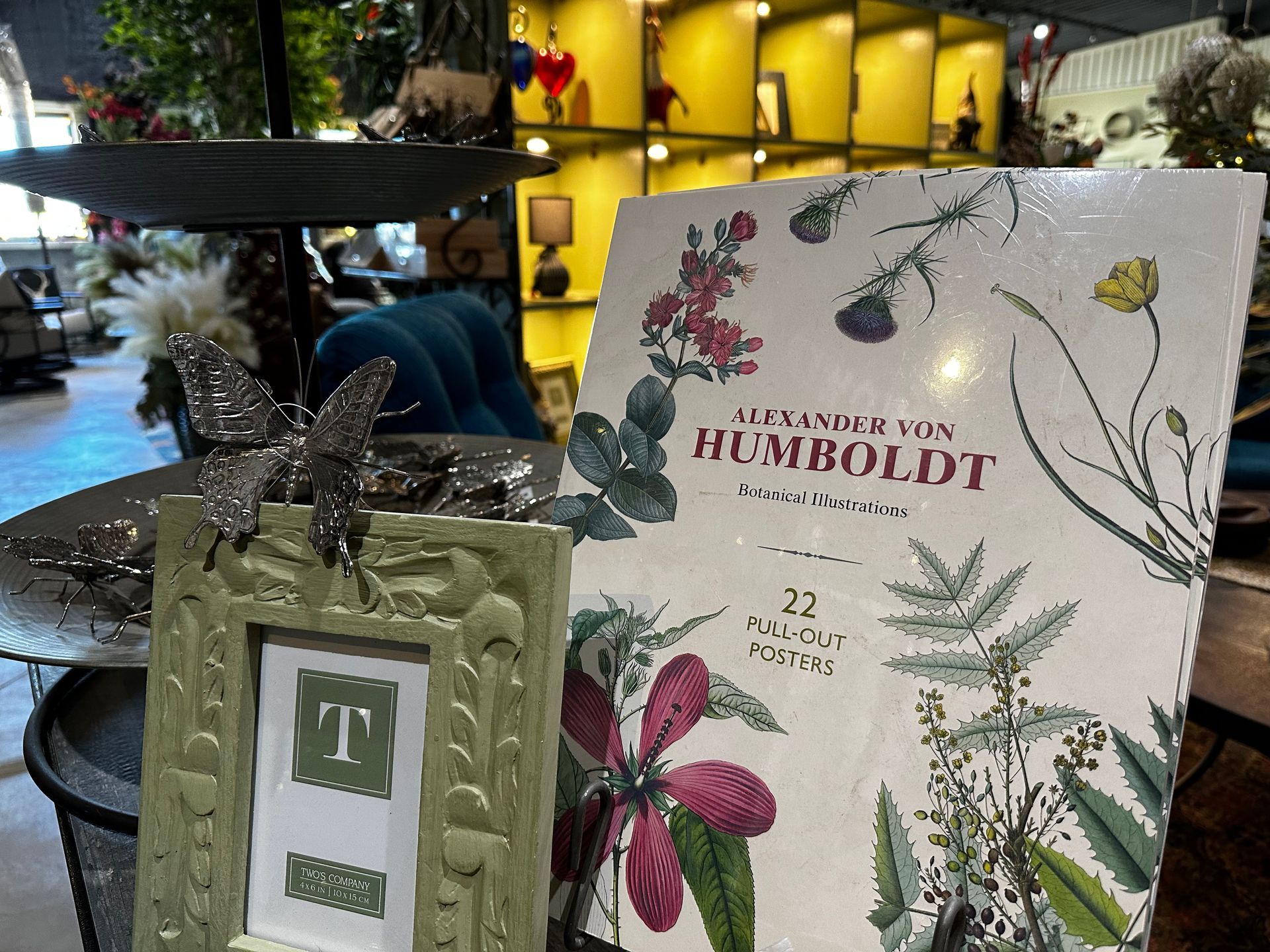 A picture frame is sitting on a table next to a book titled humboldt