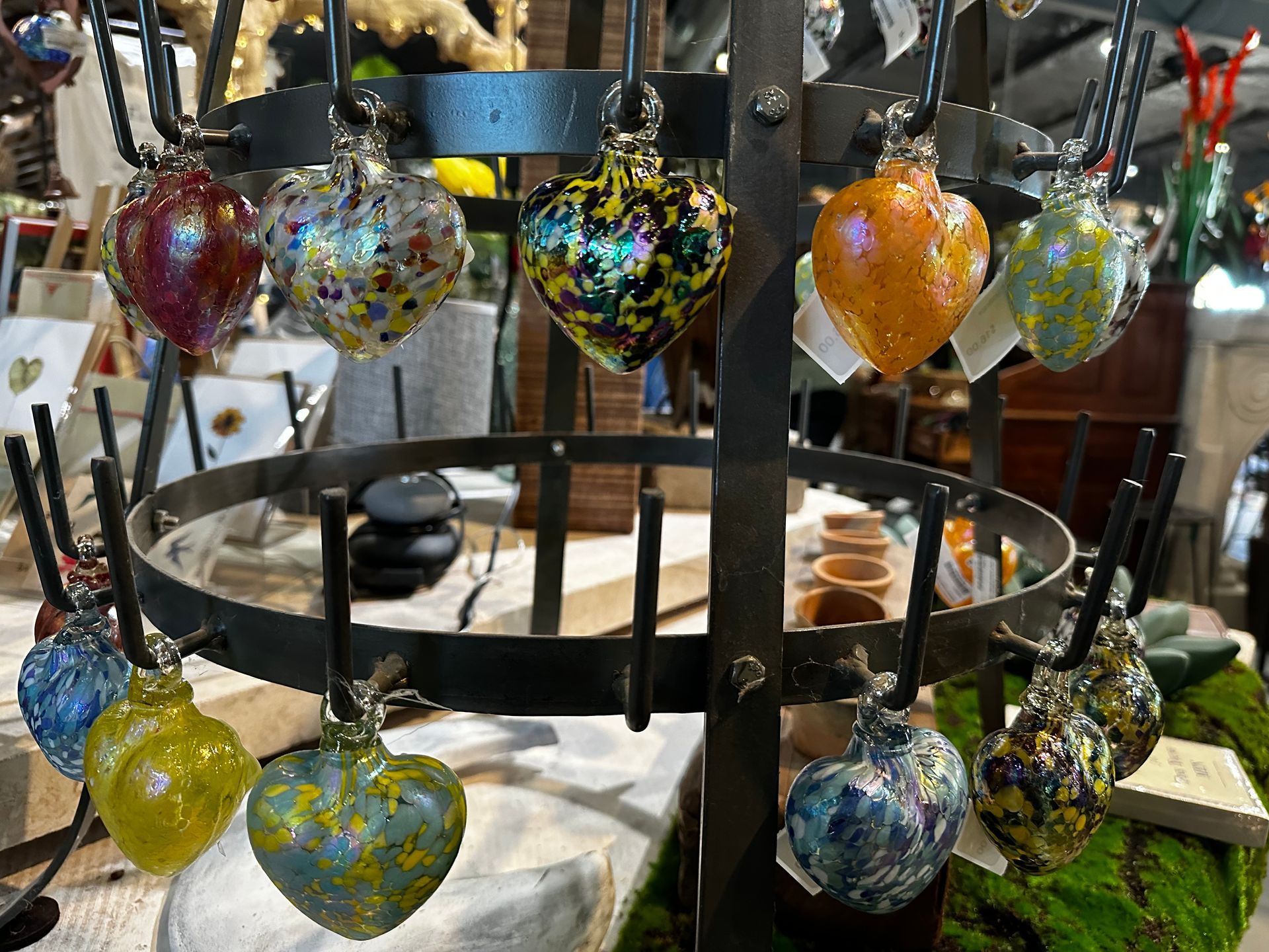 A display of glass hearts hanging from a metal ring.