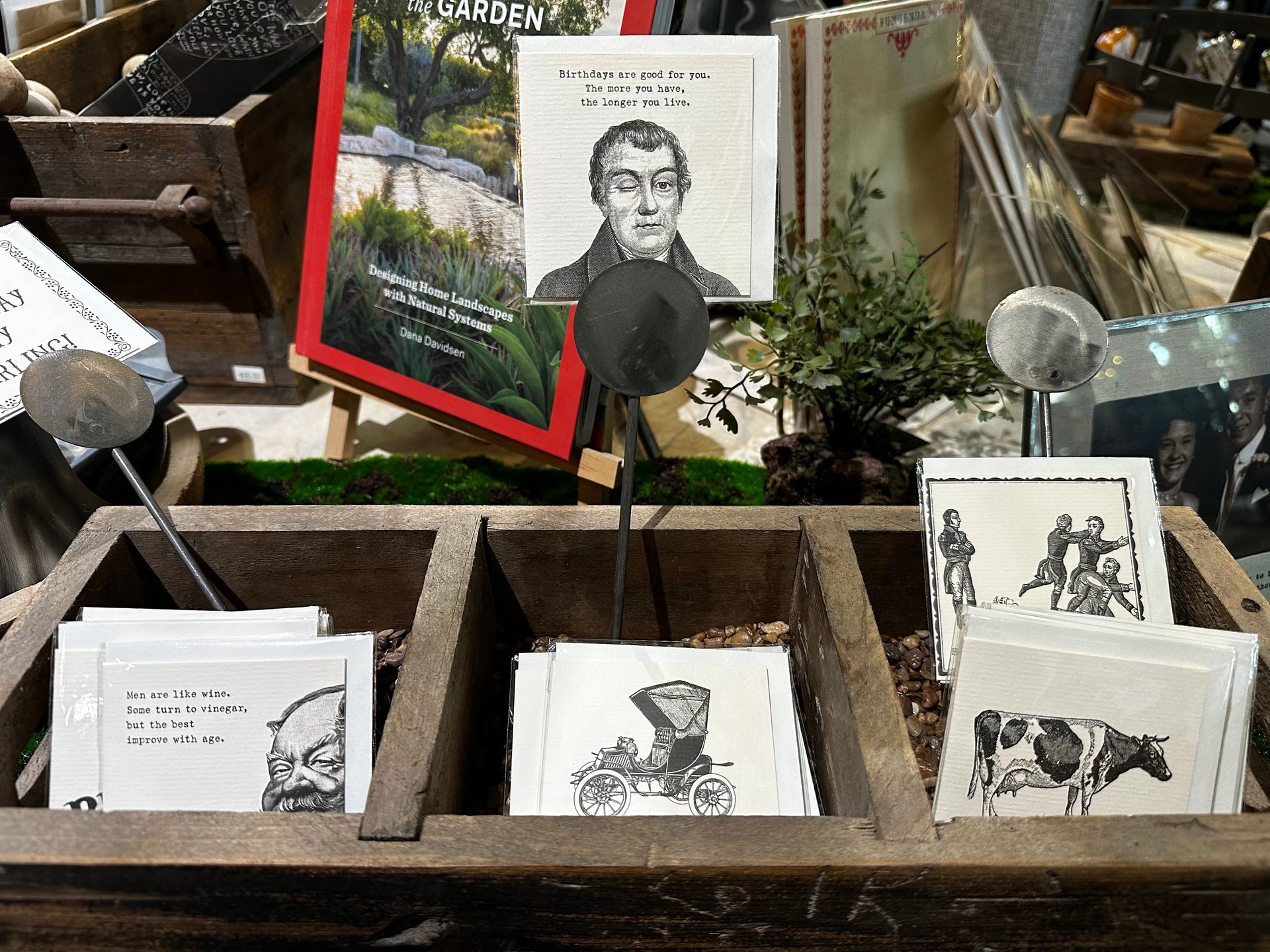 A wooden box filled with cards and a picture of a man