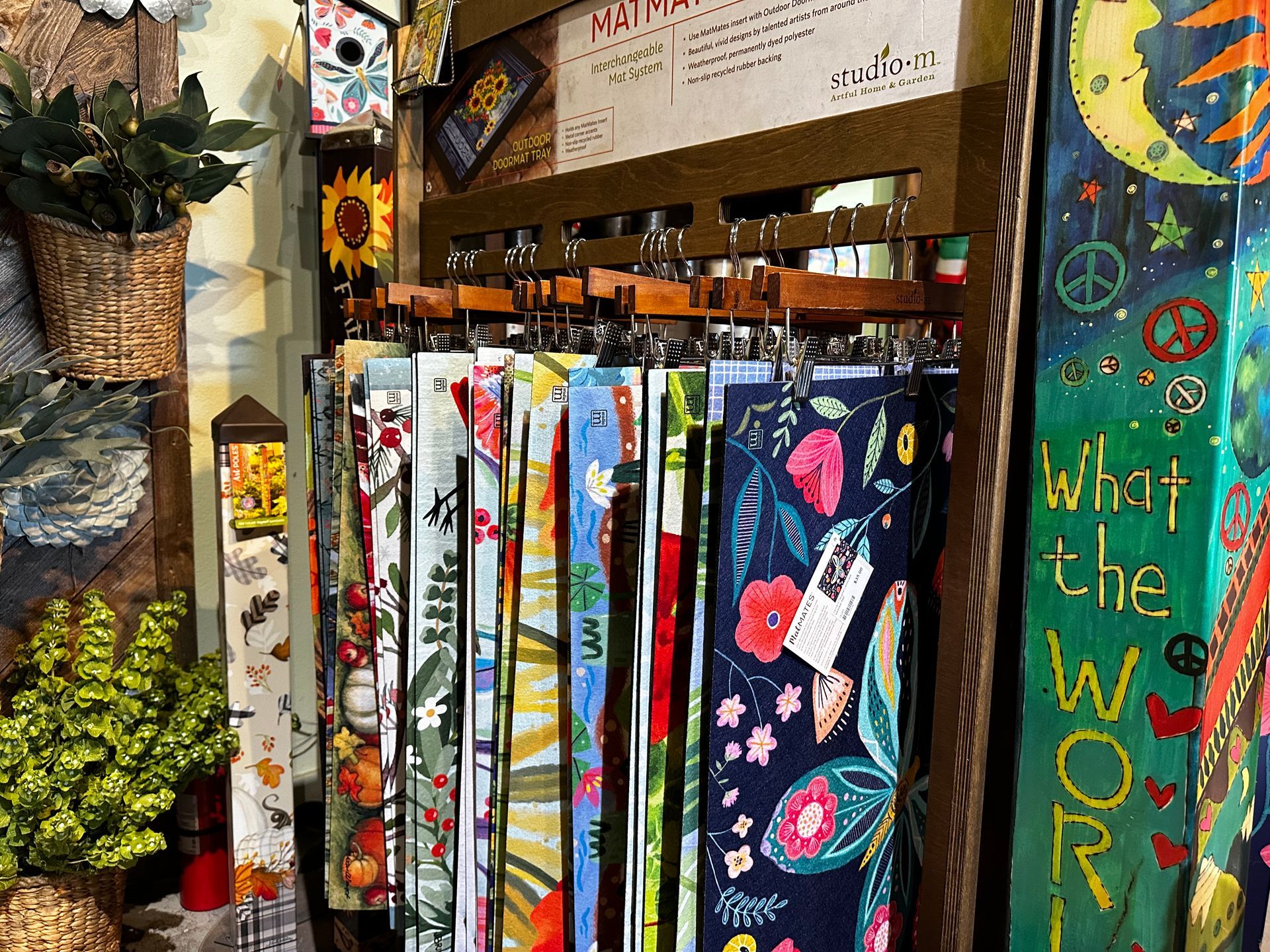 A display of colorful towels hanging on a rack in a store.