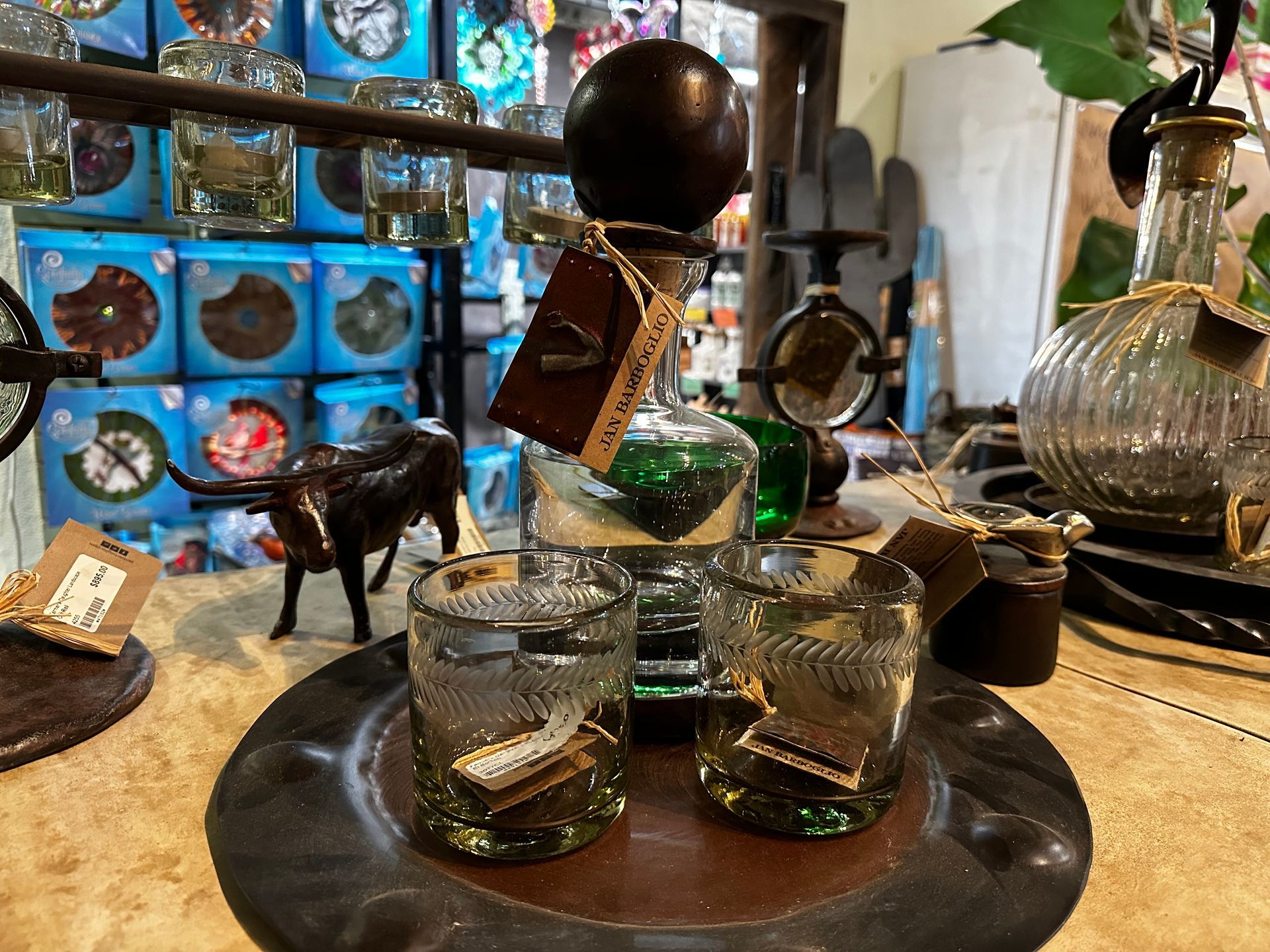 A table with a bottle and two glasses on it