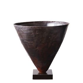 A brown vase is sitting on a wooden base on a white background.