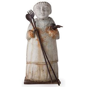 A statue of a woman holding a fork and spoon.