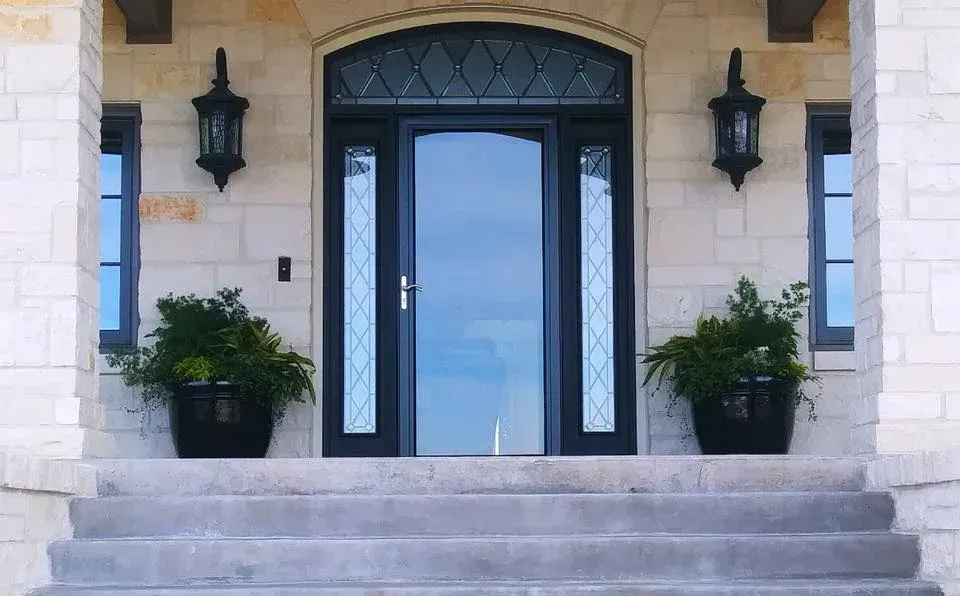 The front door of a house with two potted plants in front of it