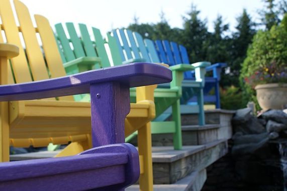 A row of colorful chairs are sitting on a set of stairs.