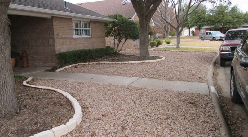 A car is parked in front of a brick house