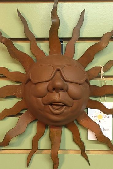A brown sun with a face and sunglasses on it