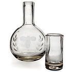 A decanter and a shot glass on a white background.