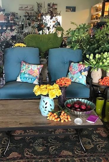 A living room with a couch and a table with flowers on it
