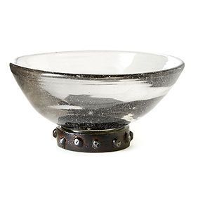 A clear glass bowl with a black base on a white background.