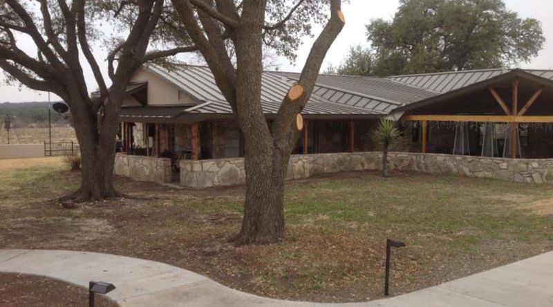 A house with a metal roof and a stone wall