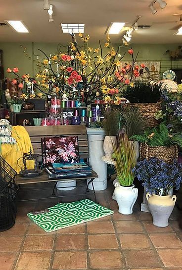 A room filled with lots of potted plants and flowers.