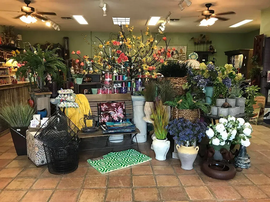 A room filled with lots of potted plants and flowers.