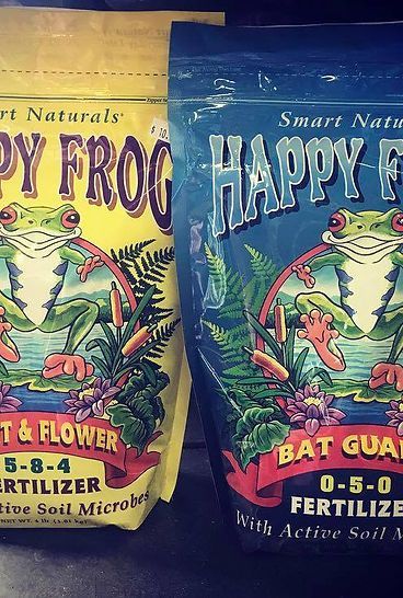 Two bags of happy frog fertilizer with frogs on them