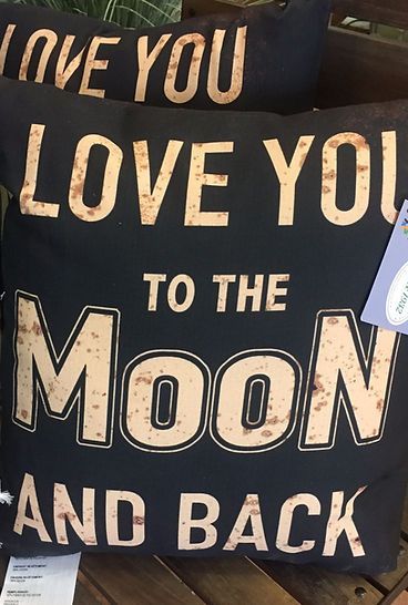A pillow that says i love you to the moon and back