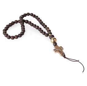 A wooden rosary with a cross on a white background.