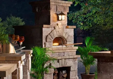 A brick fireplace with a pizza oven in the middle of it.