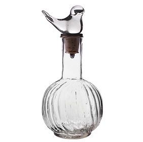 A clear glass bottle with a bird on top of it.