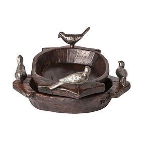 A bird bath with two birds on top of it.