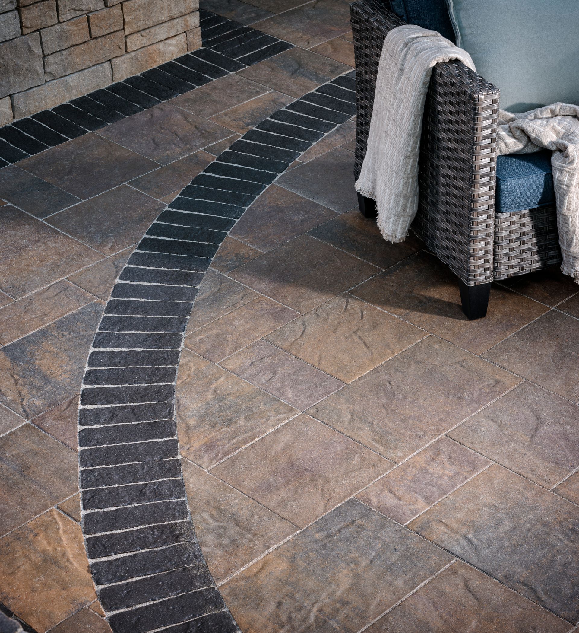 A chair with a blanket on it is sitting on a tiled floor.