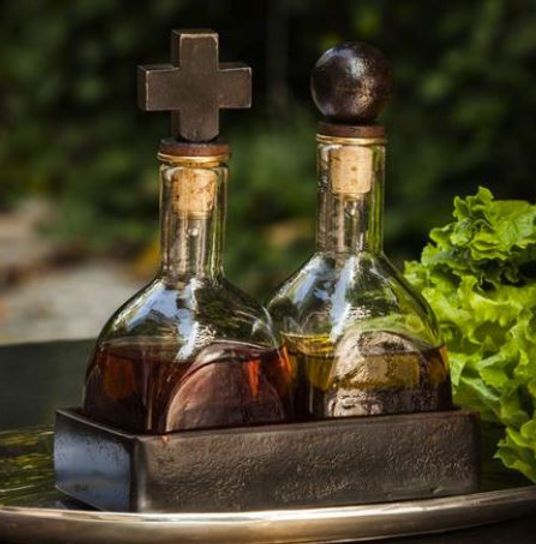 Two bottles on a tray with a cross on top of them