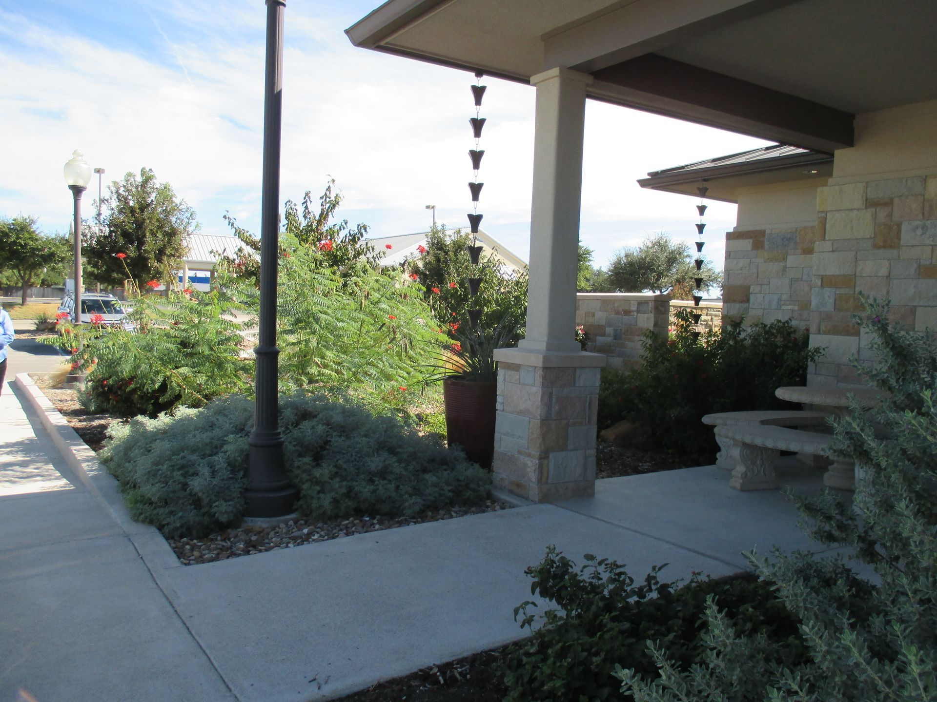 A stone building with a porch and a bench