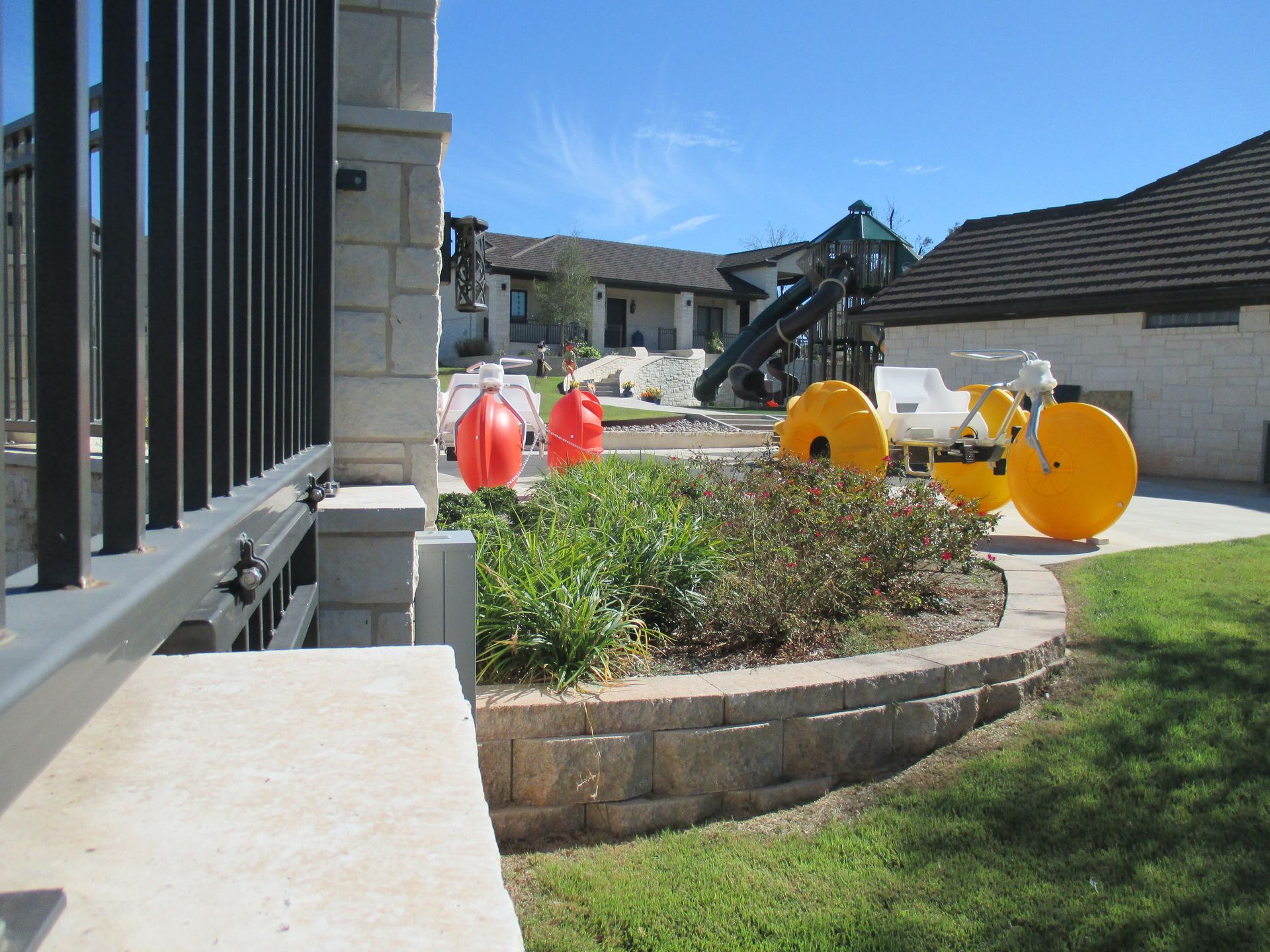 A house with a fence and a playground in the background