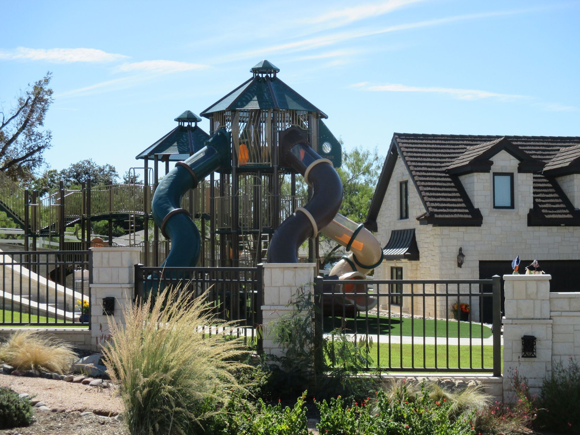 A house with a playground in front of it