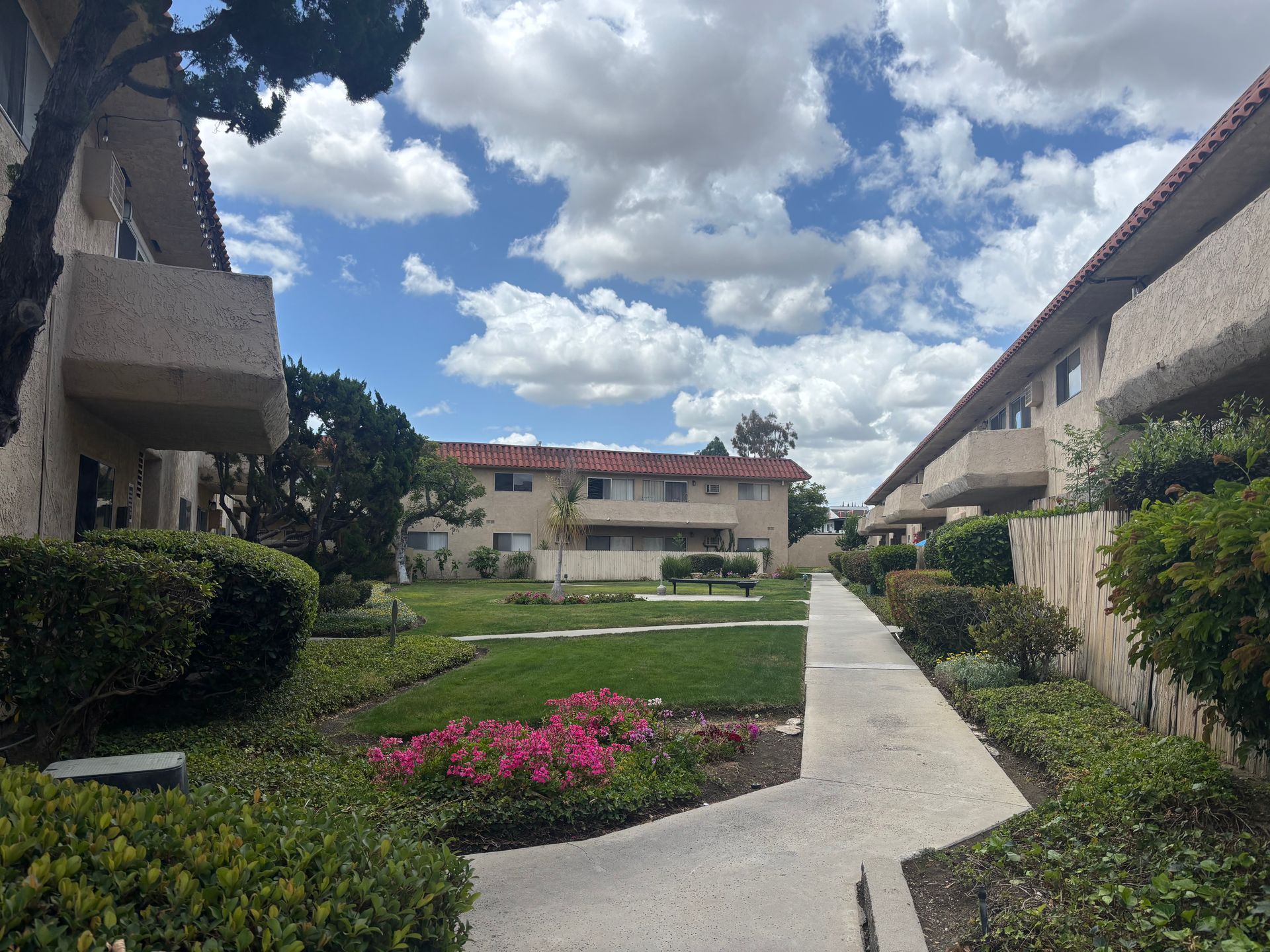 walkway through apartment buildings and grass