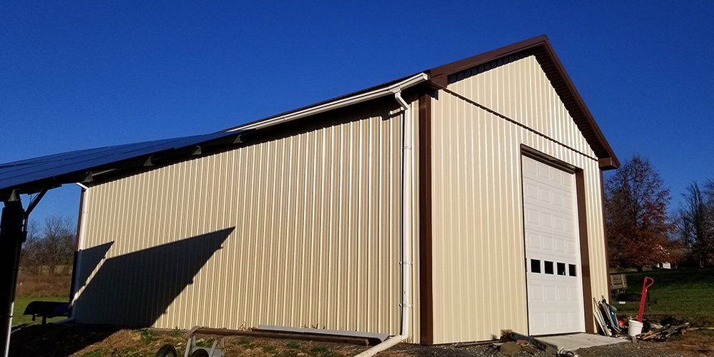 A large metal building with a solar panel on top of it.