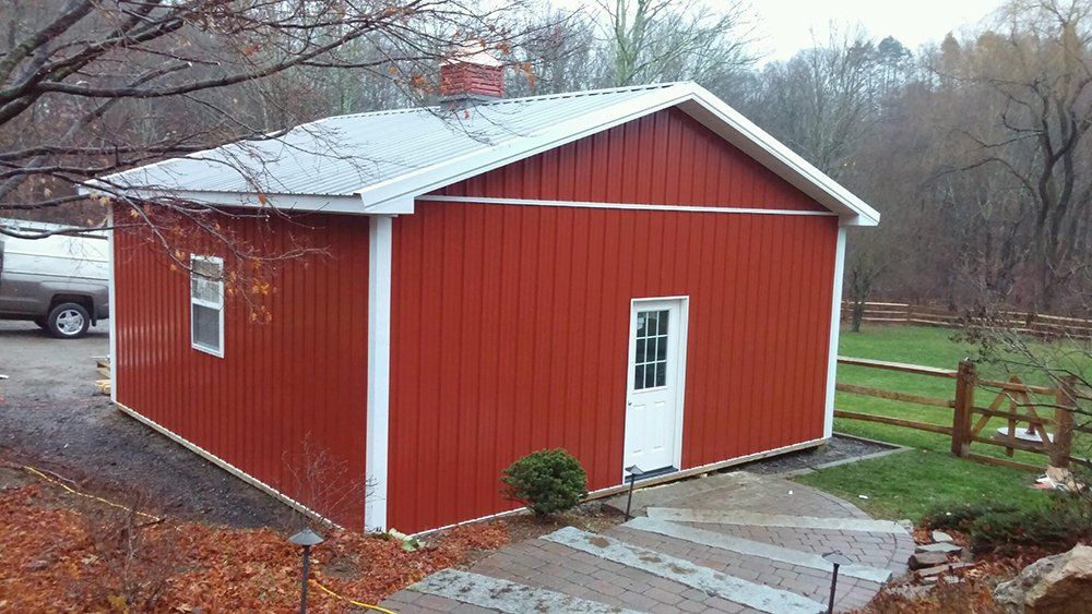 A red barn with a white trim and a white door