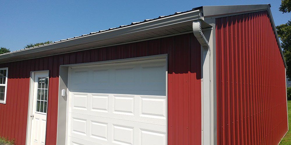 A red garage with a white garage door and a white door