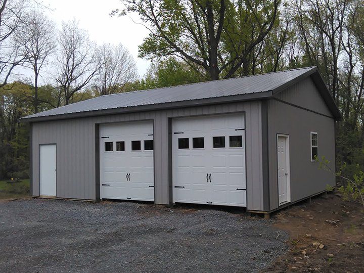 A garage with two garage doors and a window