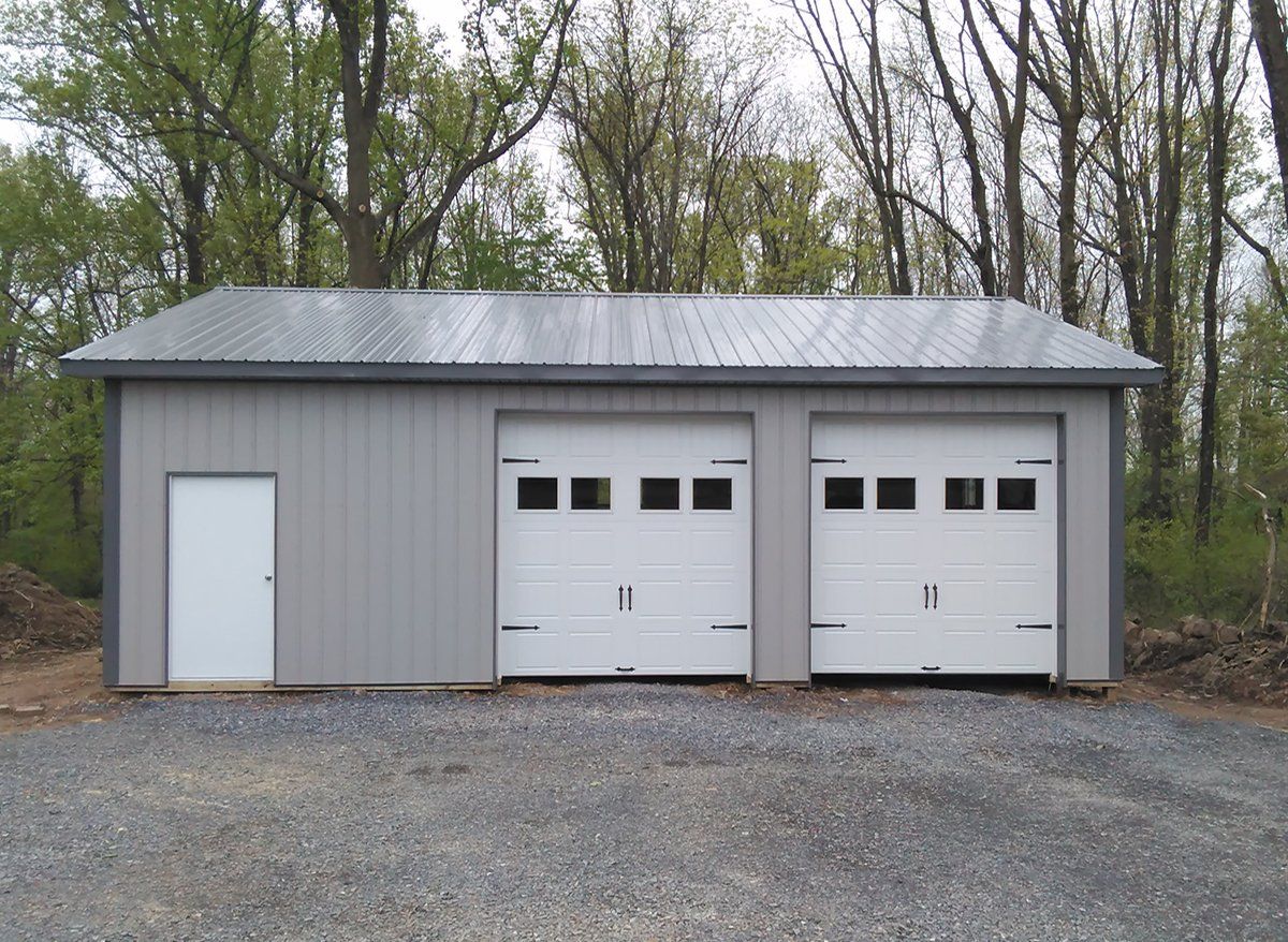 A garage with two white garage doors and a white door