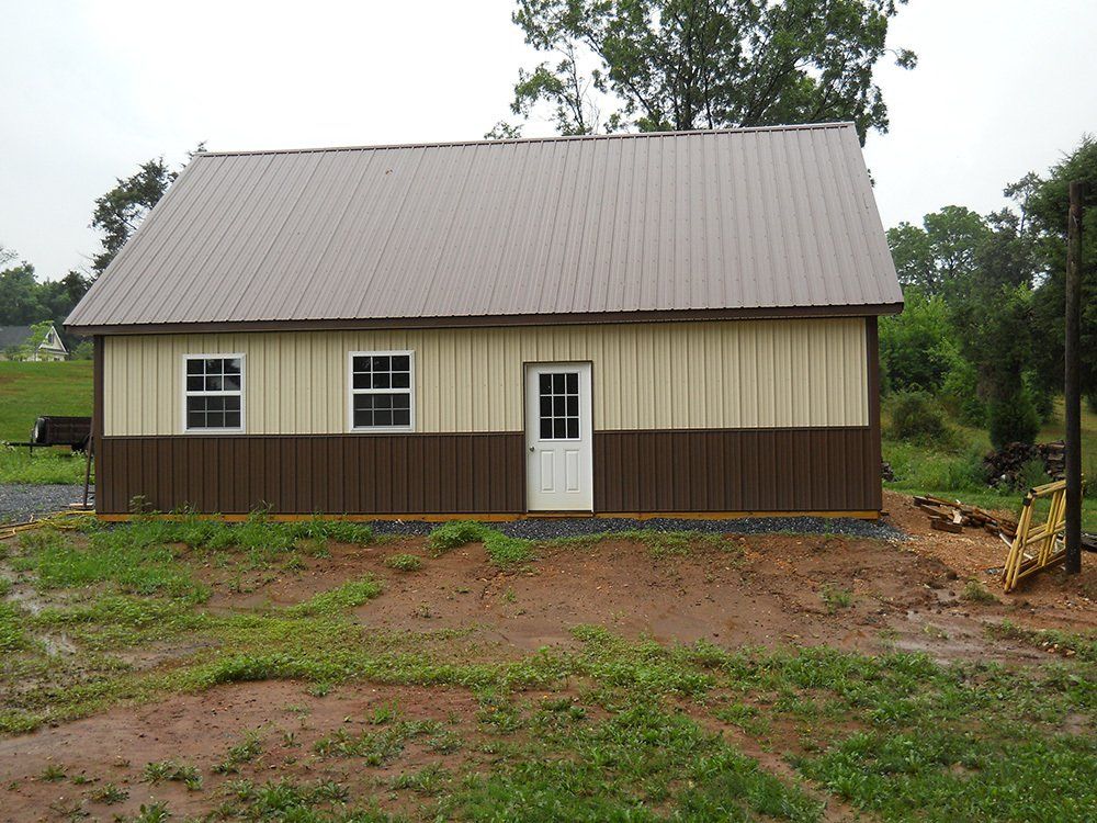 A brown and tan building with a brown roof