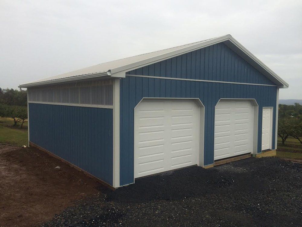 A blue and white garage with two garage doors