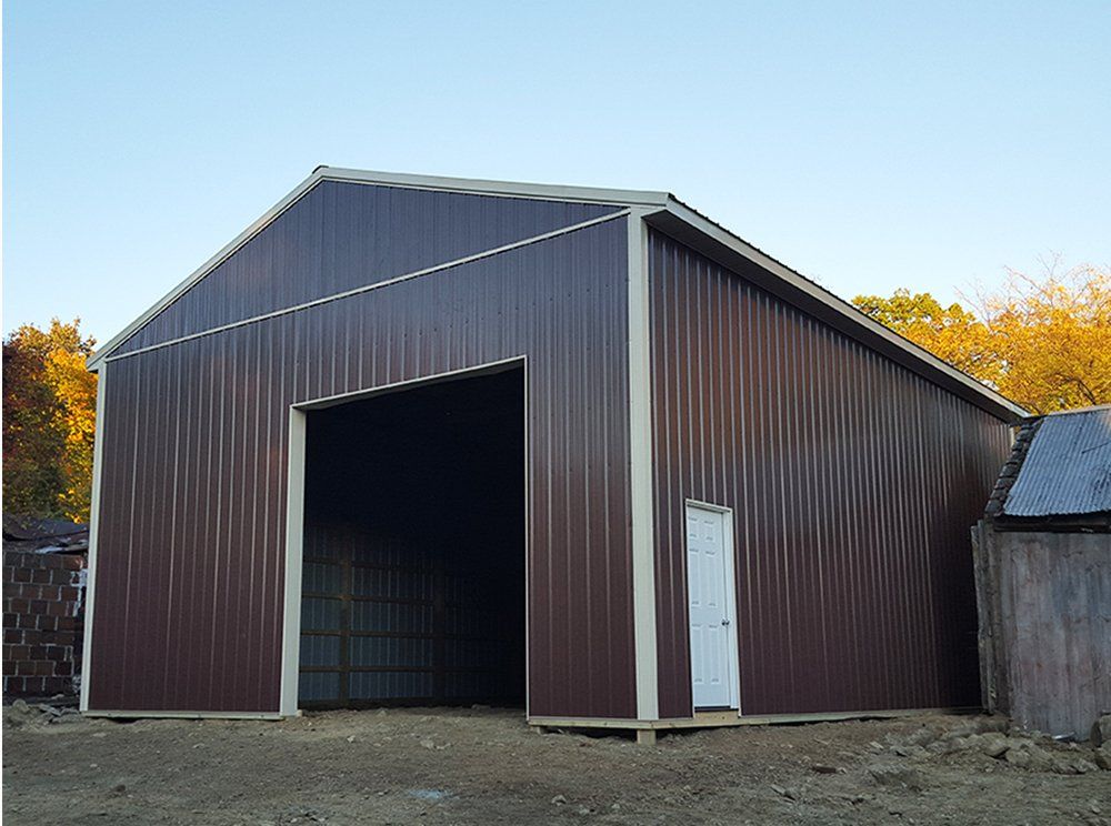 A brown metal building with a white door