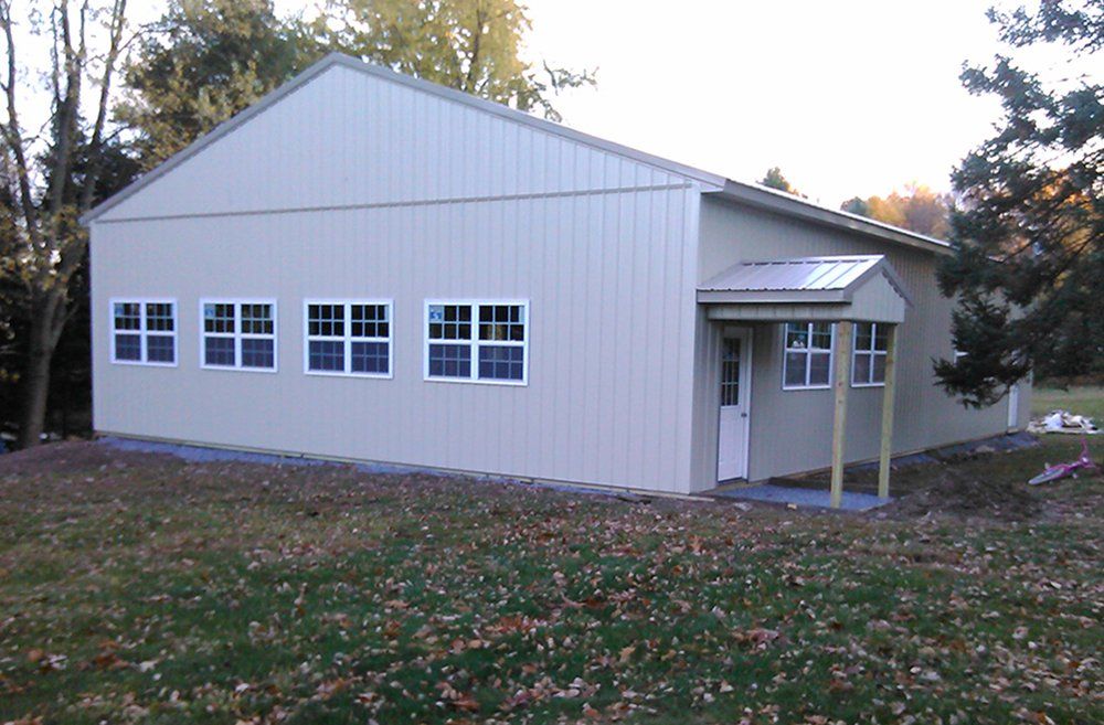 A large white building with lots of windows and a porch.
