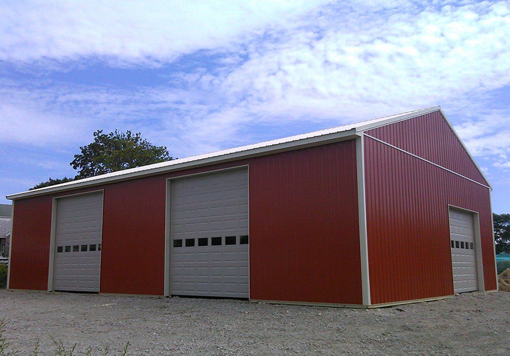 A large red barn with white garage doors
