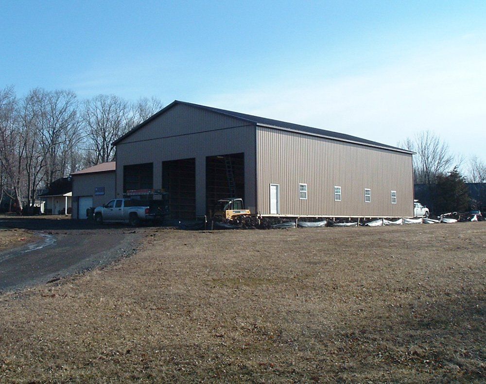 A large building with a lot of doors and a truck parked in front of it