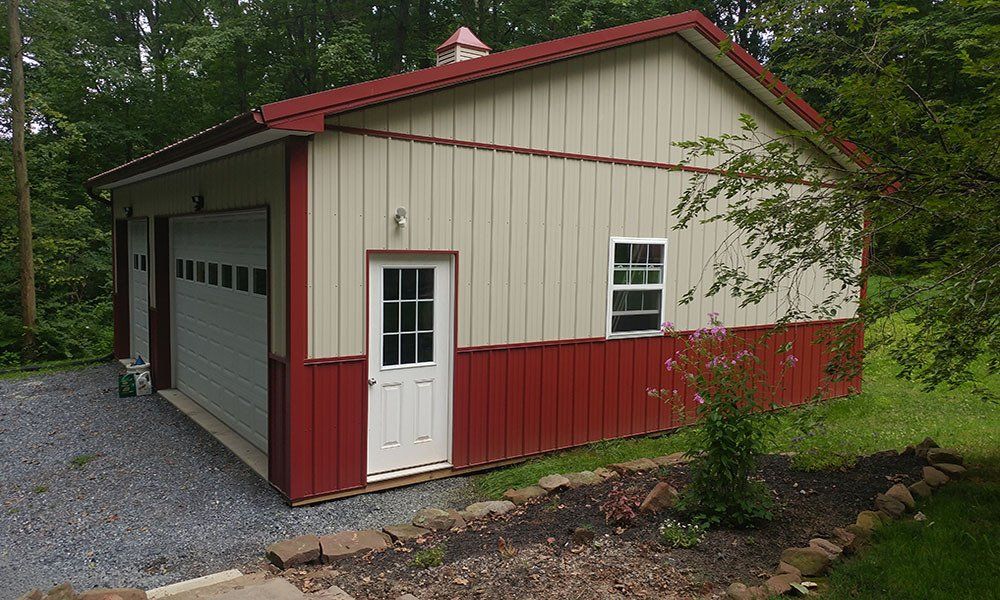 A red and white garage with a white door and window.