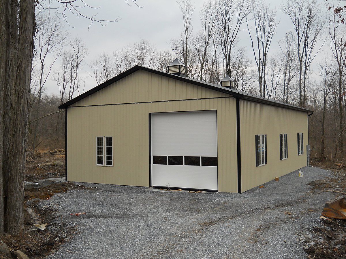 A large tan building with a white garage door
