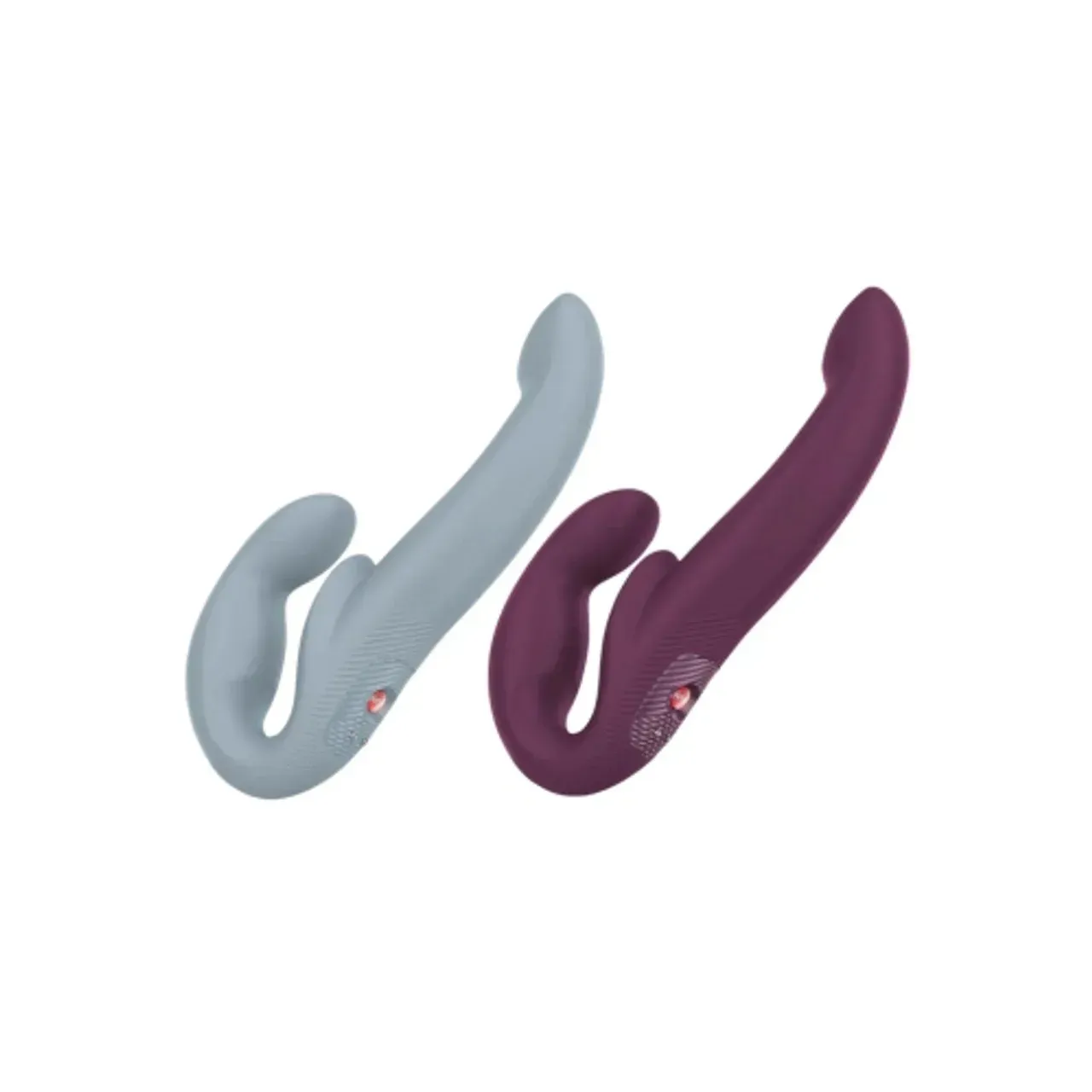 Two purple and gray toys are sitting next to each other on a white background.