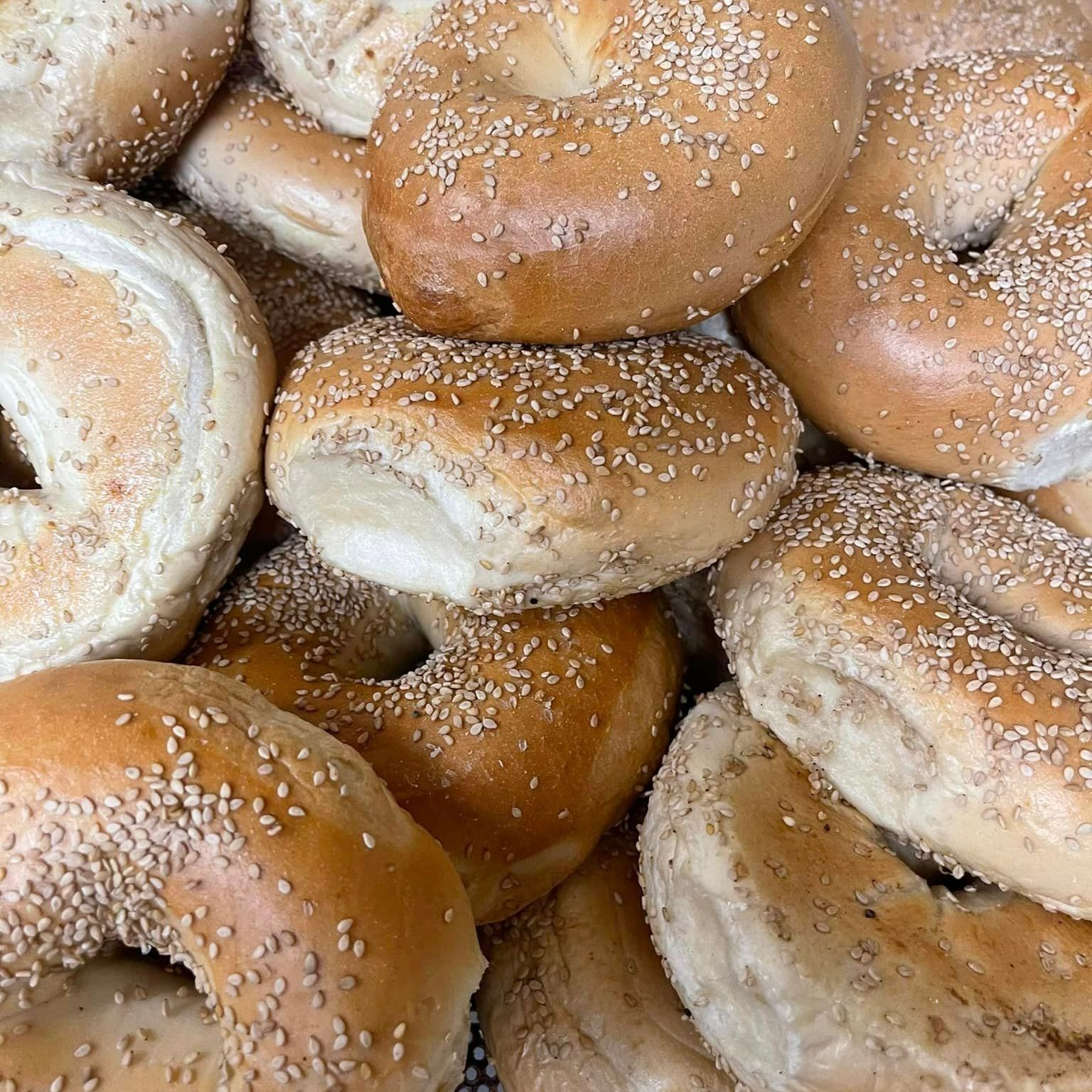 A Pile Of Bagels With Sesame Seeds On Them - Mahopac, NY - Our Town Bagels & Bakery