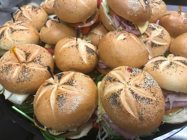 A Plate Of Food With Sliced Cheese Tomatoes And Lettuce - Mahopac, NY - Our Town Bagels & Bakery