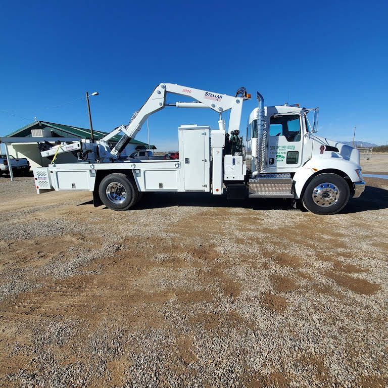 a white truck with a crane attached to it