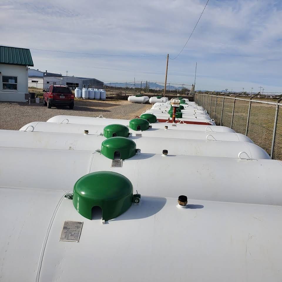 a row of white tanks with green caps on top