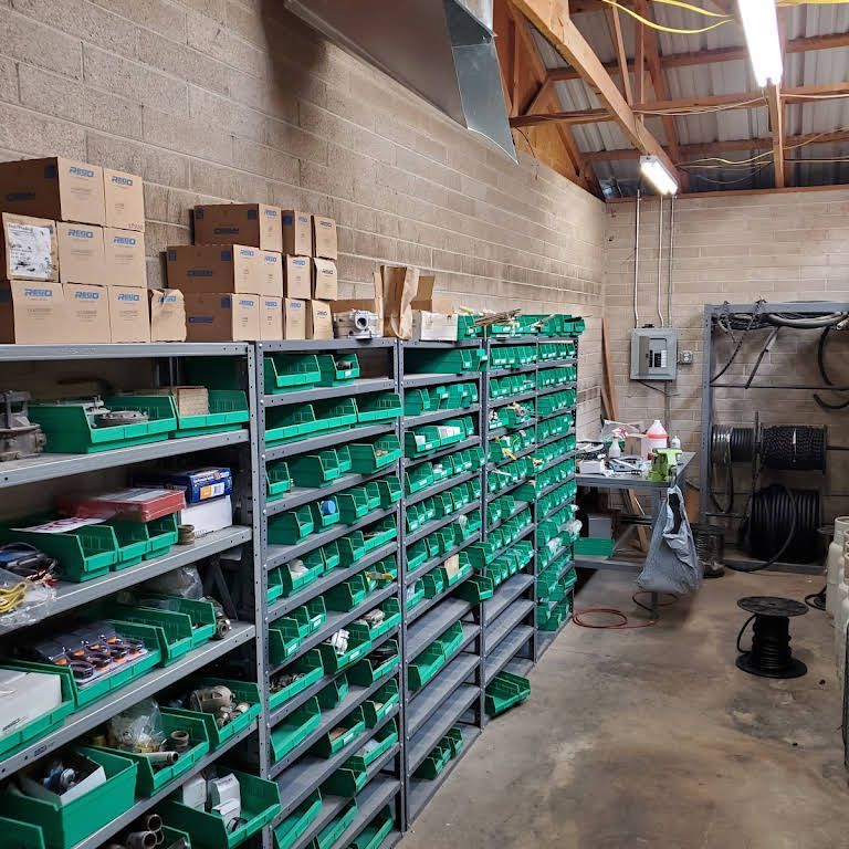 a warehouse filled with lots of green bins and boxes
