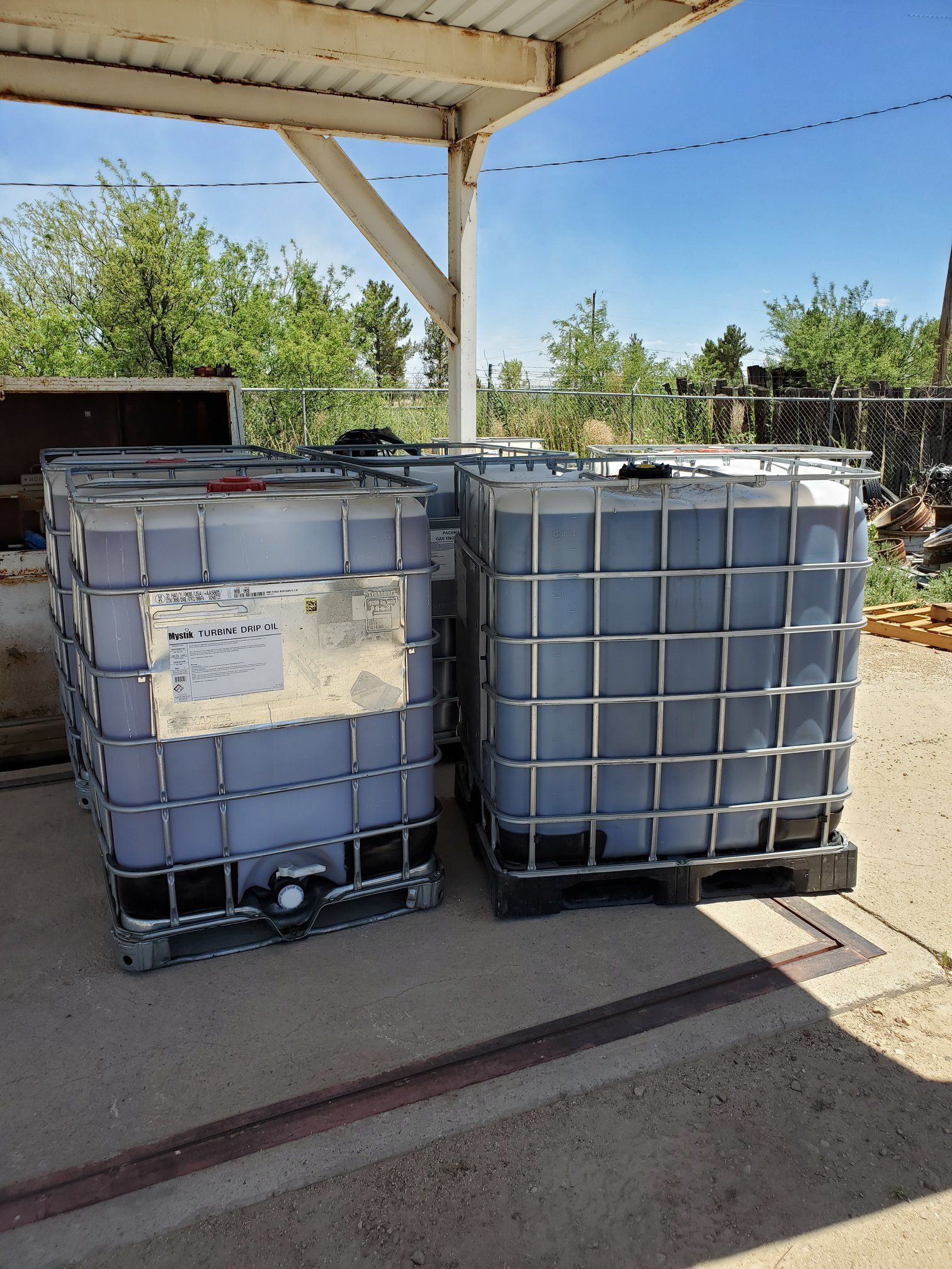 two large containers are stacked on top of each other under a canopy .