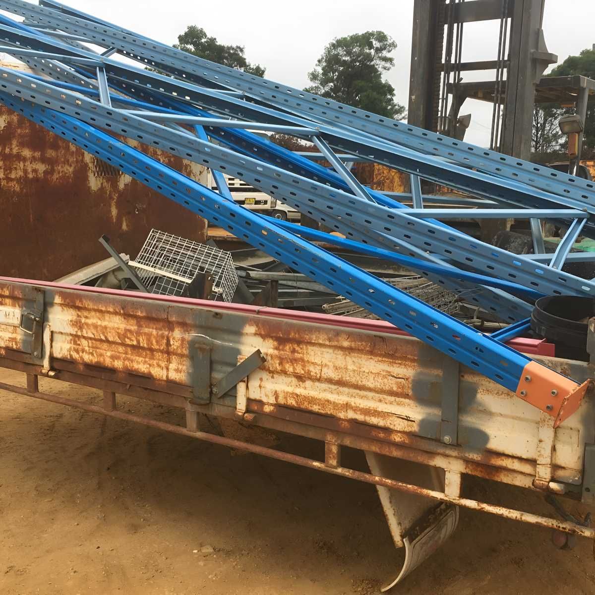 A Truck With a Bunch of Blue Pallet Racks in It — Anderson Waste Services in Moss Vale, NSW